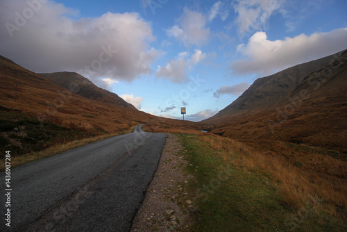 Loch Etive Bright sun illuminates the rugged peaks and rolling valleys of Glencoe in the Scottish Highlands, showcasing the wild natural beauty of Scotland under a clear blue sky.