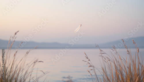 Serene landscape featuring delicate feather floating above calm waters, surrounded by tall grasses. soft pastel colors of sky create tranquil atmosphere, evoking sense of peace and reflection