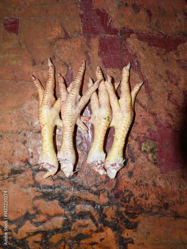 fresh chicken feet in the market, A detailed close-up shot showcasing the texture of fresh chicken feet, highlighting its unique skin pattern, A pile of fresh chicken feet, closeup in chicken shop