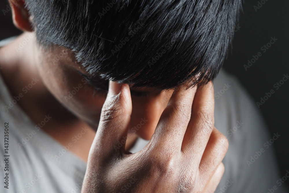 Fototapeta premium Young person showing deep contemplation or stress indoors