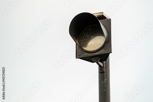 Daylight close-up of traffic light signal at urban intersection for vehicle safety alert