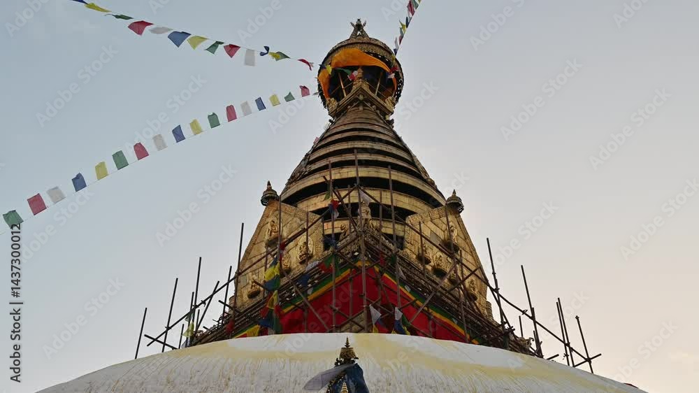 Prayer flags blowing by the wind over the Swayambhunath Stupa in Kathmandu, Nepal.