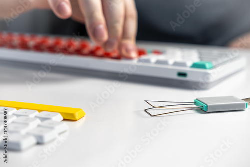 Mechanical keyboard enthusiast using keycap puller tool for custom switch replacement setup