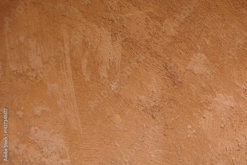Rough orange cement plaster texture, close-up photo