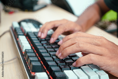 Close up of a male hands typing on a modern keyboard
