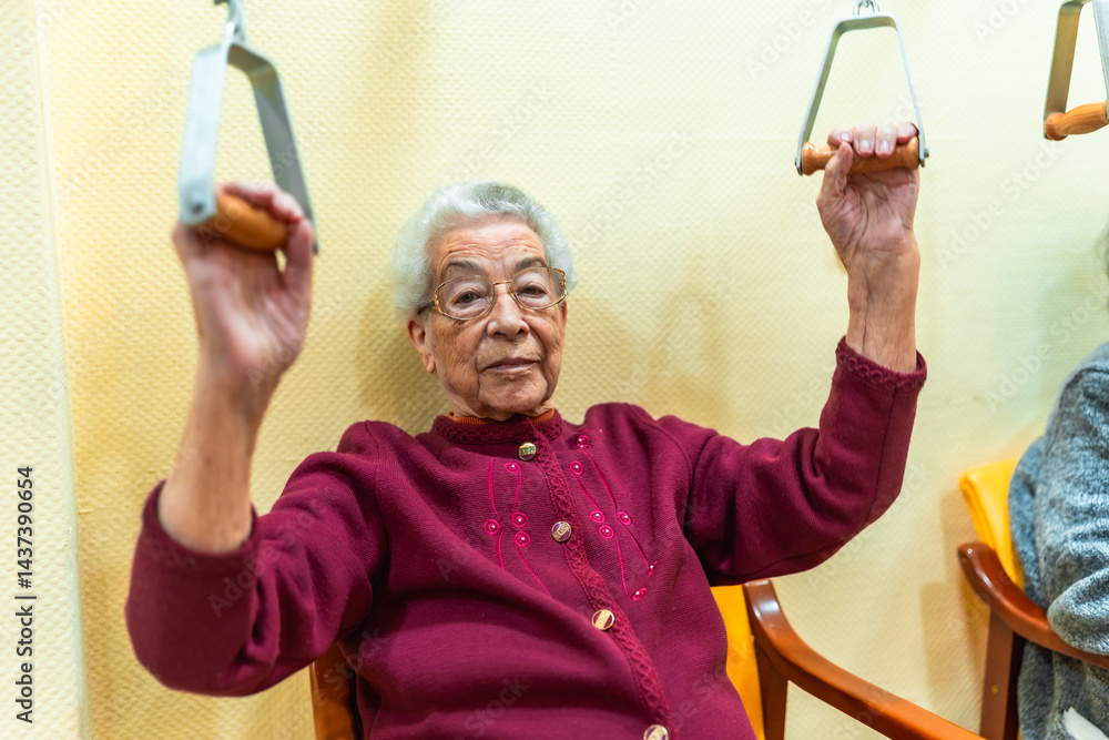 Elderly woman exercising with pulley machine in nursing home
