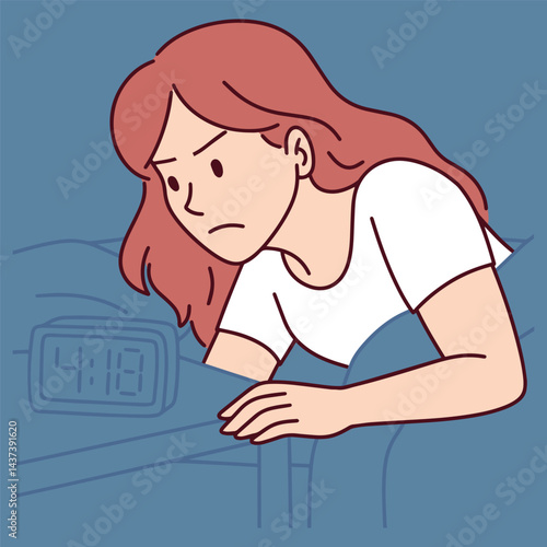 Young woman with red hair suffering from insomnia sits in bed and looks at alarm clock with frustrated expression, feeling anxious and unable to sleep at night