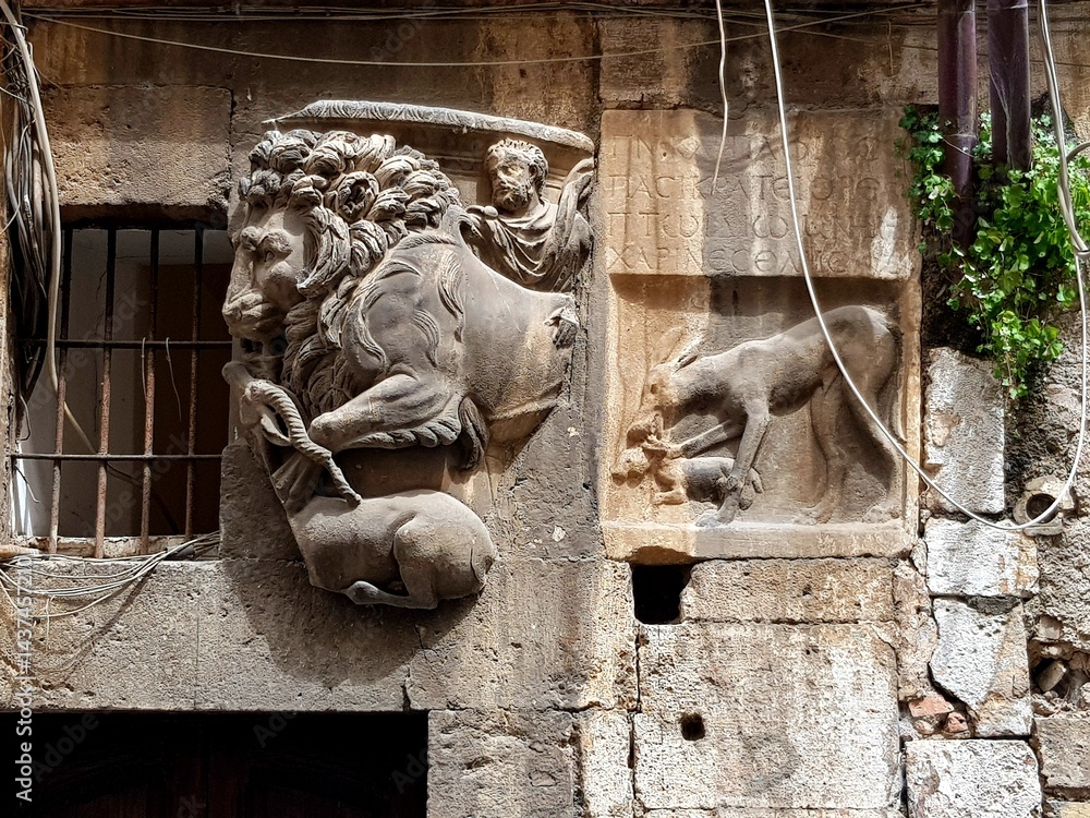 Sculpture of lion and lioness on the facade of a building