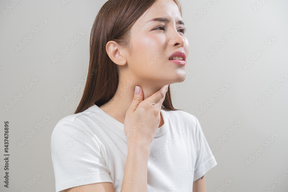 Sickness in inflaming asian young woman, girl use hand check self touch at sore throat, pain thyroid gland on neck or disease reflux, acid of suffer people on wall background. Medical and healthcare. Sickness in inflaming asian young woman, girl use hand check self touch at sore throat, pain thyroid gland on neck or disease reflux, acid of suffer people on wall background. Medical and healthcare.