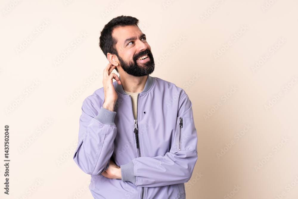 Caucasian man with beard wearing a jacket over isolated background thinking an idea Caucasian man with beard wearing a jacket over isolated background thinking an idea