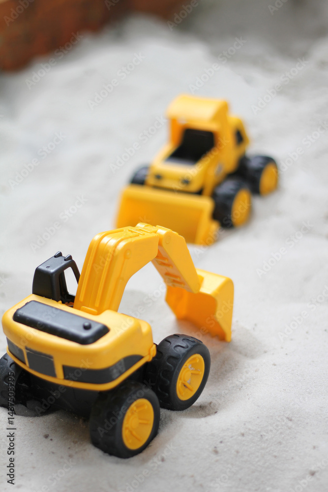 Toy excavator in sandpit Toy excavator in sandpit
