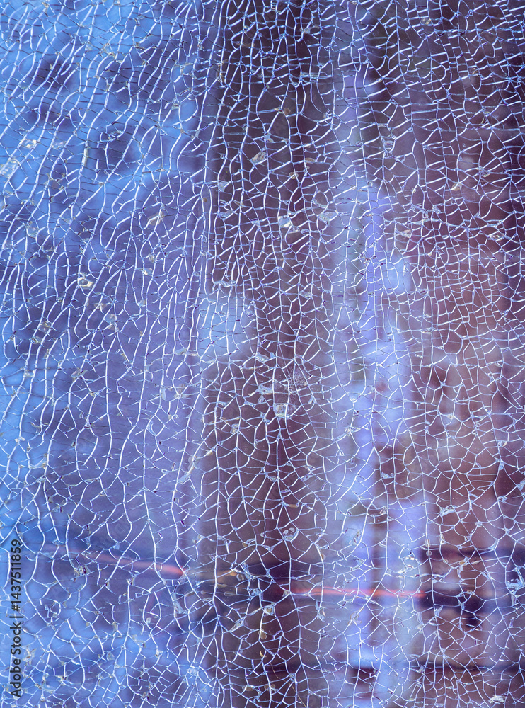 Cracks on the glass surface background. Texture of broken tempered glass pane too many small irregular shape pieces holding together. Detail of cracked broken glass cracked by impact, Space for text.
