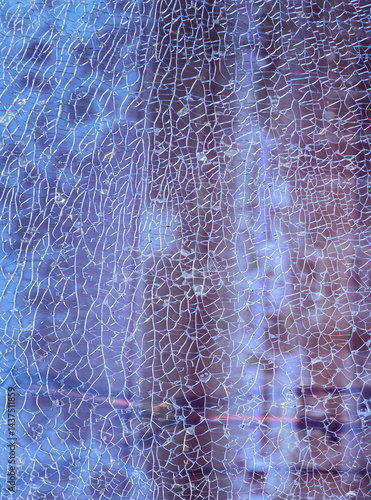 Obraz na płótnie Cracks on the glass surface background. Texture of broken tempered glass pane too many small irregular shape pieces holding together. Detail of cracked broken glass cracked by impact, Space for text. w salonie