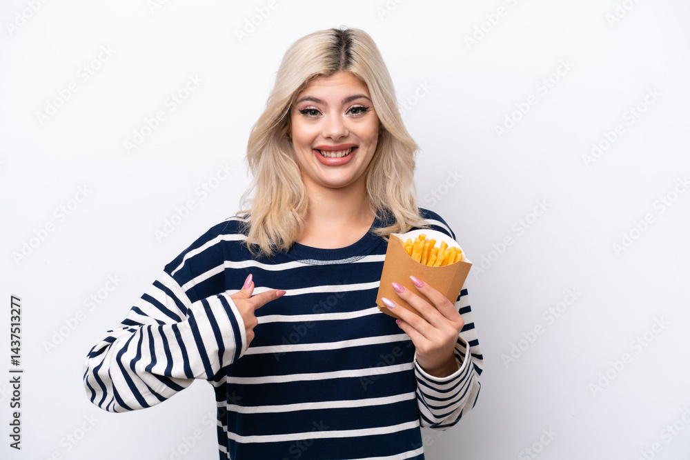 Young Russian woman catching french fries isolated on white background with surprise facial expression Young Russian woman catching french fries isolated on white background with surprise facial expression