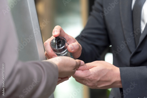 Obraz na płótnie cleaning hand with alcohol sanitizer gel at entrance office w salonie