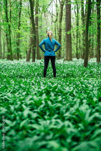 Obraz na płótnie Woman athlete in sportswear standing confidently in forest, concept of fitness and healthy lifestyle w salonie