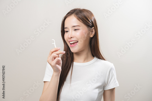 Wallpaper Mural Flossing teeth, dental care hygiene, asian young woman flossing teeth with dental floss pick, smile happy with perfect white teeth, using tooth floss cleaning, healthy teeth isolated on background. Torontodigital.ca