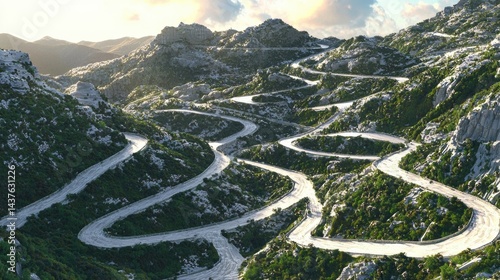 Winding mountain road snakes through rugged terrain under a bright sky.