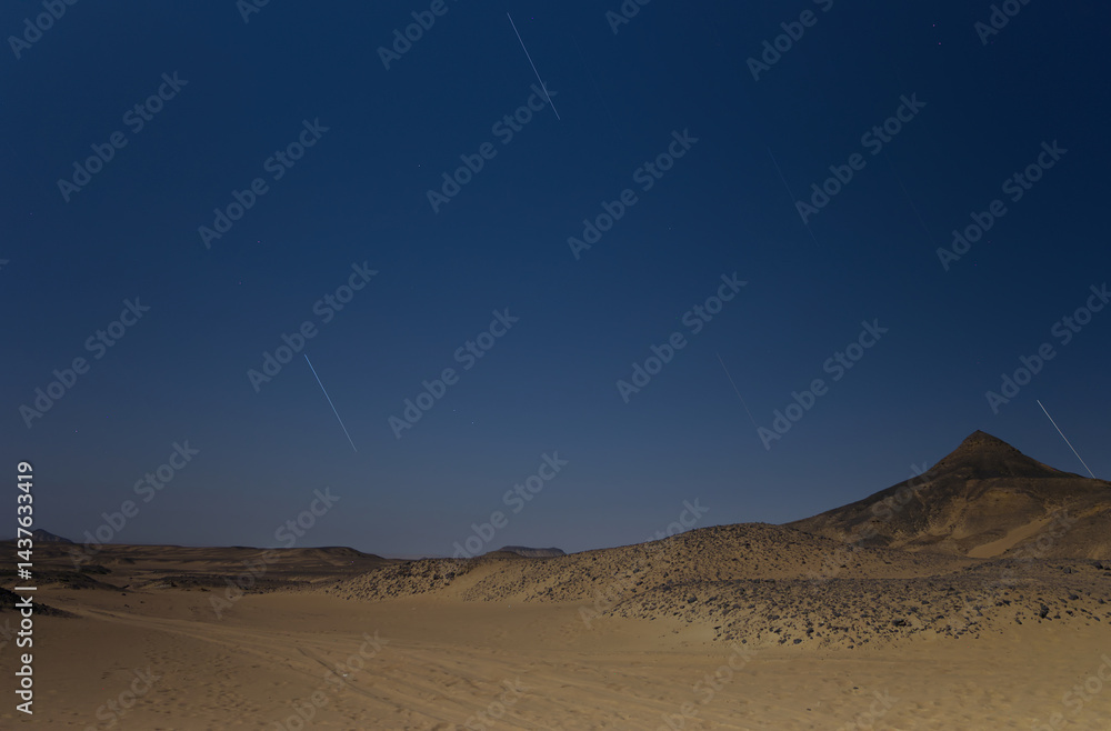 Star trails in the black desert night in Egypt