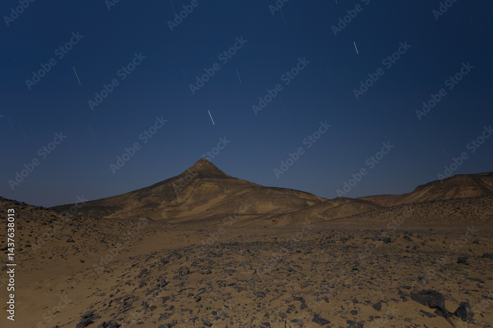 Star trails in the black desert night in Egypt