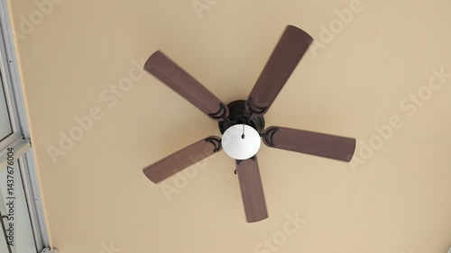 Ceiling fan fast spinning brown fin white lantern