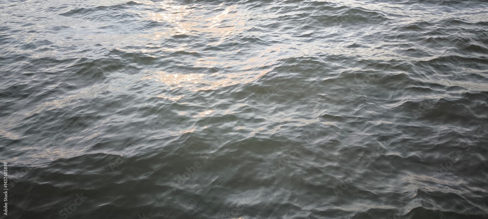 Fototapeta premium Water waves and evening light for background