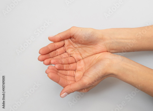Obraz na plátně Open hands cupped together, offering or receiving something.