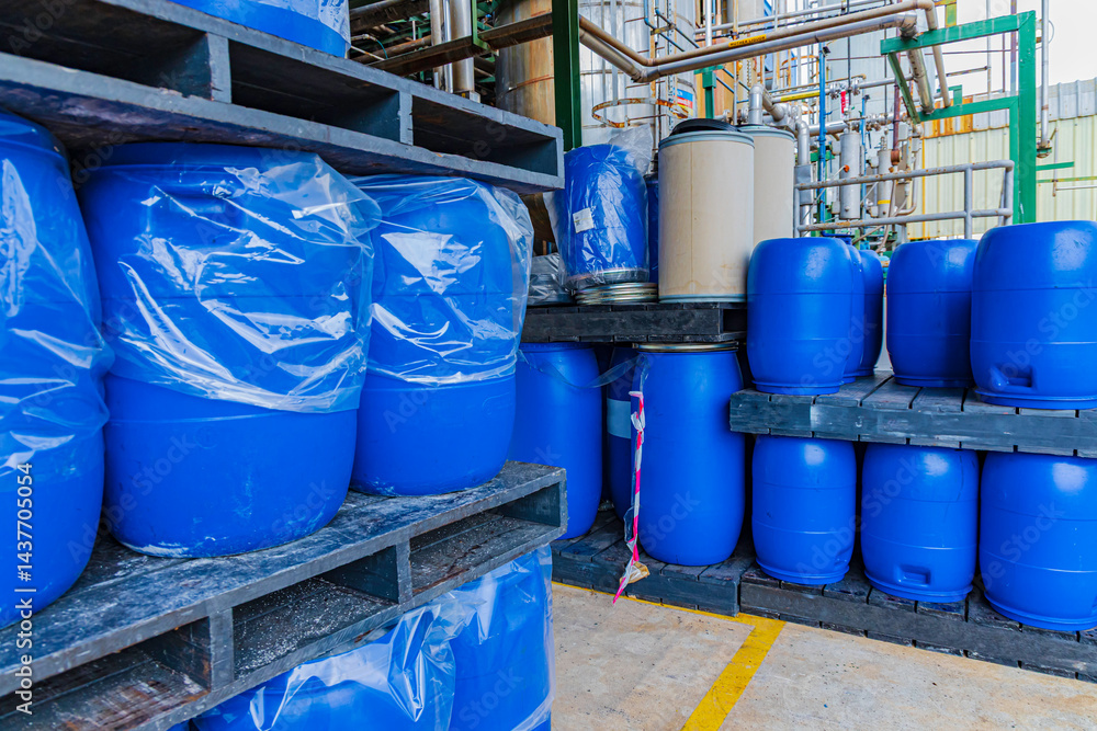 Tank working in chemicals production factory and gas masks lifting plastic canisters with hazardous and toxic