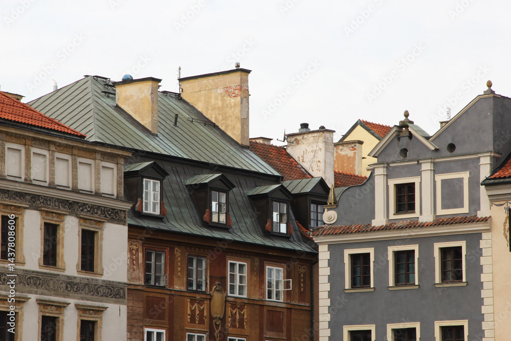 Traditional European architecture with vibrant facades, red clay roof tiles, dormer windows, and ornate exterior wall decorations in a picturesque old town setting Traditional European architecture with vibrant facades, red clay roof tiles, dormer windows, and ornate exterior wall decorations in a picturesque old town setting