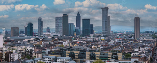 Obraz na płótnie Aerial view of Frankfurt, Germany, highlighting the Messeturm, Tower 185, and Hauptbahnhof. Modern and traditional buildings with hills in the distance. w salonie