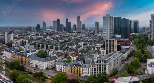 Obraz na płótnie Aerial view of Frankfurt, Germany, featuring the Commerzbank Tower, Main Tower, and Hauptbahnhof. Sunset colors highlight the mix of architecture. w salonie