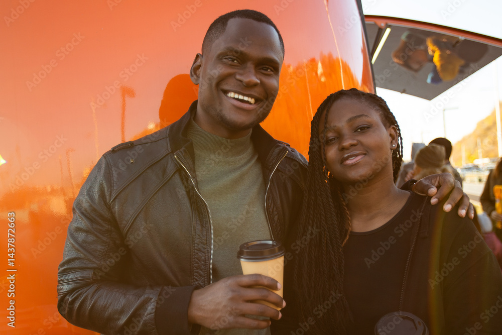 Smiling african american friends enjoy city walk at sunset. Concept of friendship, positive emotions, communication, connection