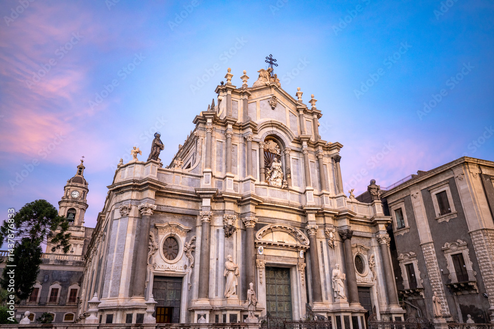 Fototapeta premium Facade of the Baroque Cathedral Basilica of Saint Agatha in Catania, Sicily, Italy, in the golden light of sunset