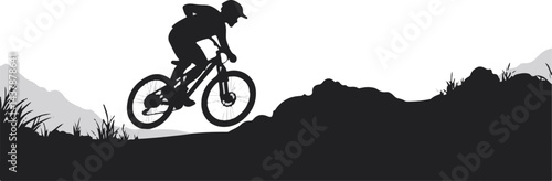 Mountain Biker Silhouette Jumping Over Rugged Terrain