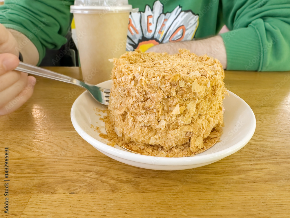 Tasting a big piece of sweet cake