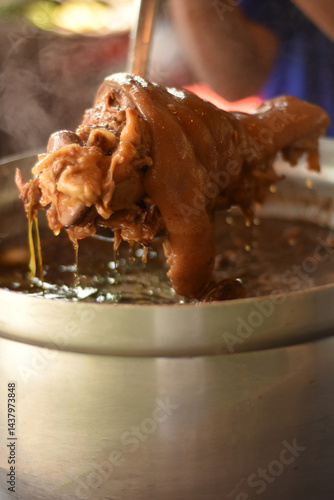 Delicious stewed hot pork leg for serve. Stewed leg pork style chinese food on steamed pot. Pork stewed in the gravy, knuckle of pork and egg boiled in the gravy.