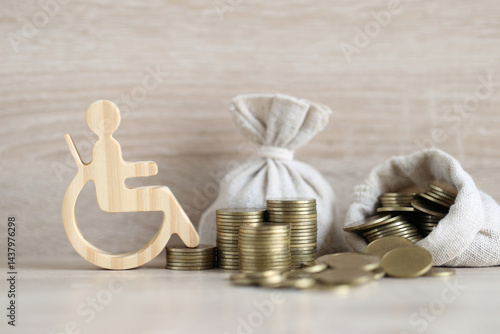 Man on wheelchair and coin money on wooden background,Save money for prepare in future and handicapped person concept