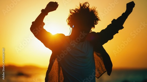A joyful silhouette of a person dancing at sunset, with the sun creating a halo effect in the sky.