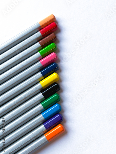 Many colorful wooden pencils on white background, flat lay. Space for text