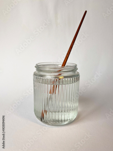 Artistic brushes in a jar with water on the white background. Artist tools. Selective focus.