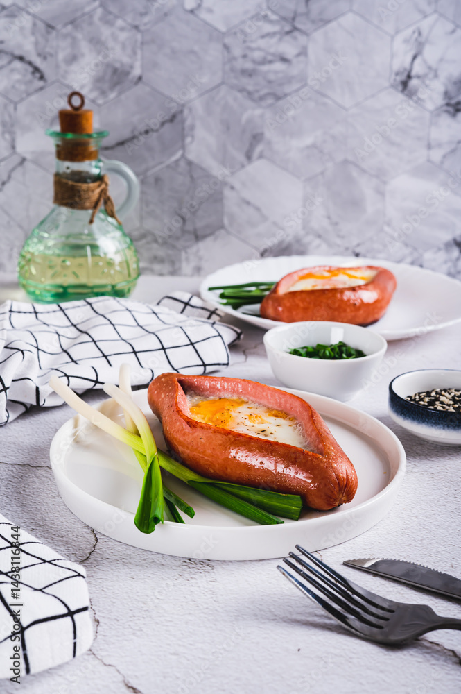 Fried egg in a sausage in the form of khachapuri on a plate on the table vertical view