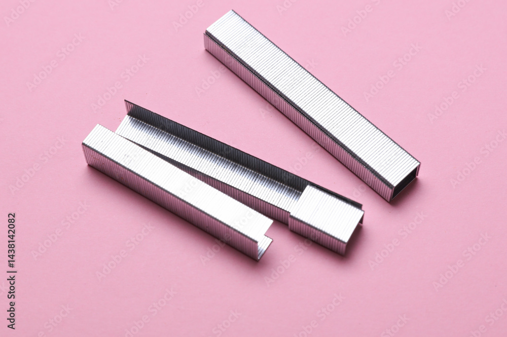 Metal staples on a pink background Metal staples on a pink background