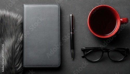 A cup of coffee, a pen, glasses and a wallet on a table