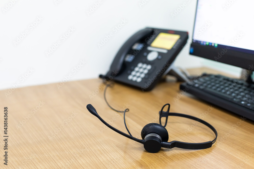 VOIP headset for callcenter on desk at customer service office. Communication support for sale support and telemaketing Helpdeskac
