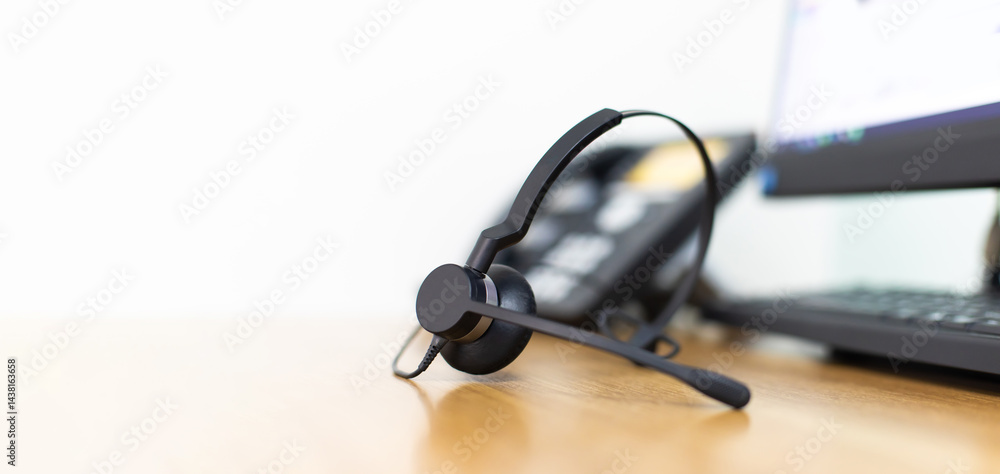 VOIP headset for callcenter on desk at customer service office. Communication support for sale support and telemaketing Helpdeskac