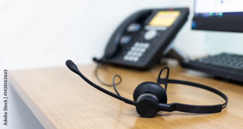 VOIP headset for callcenter on desk at customer service office. Communication support for sale support and telemaketing Helpdeskac