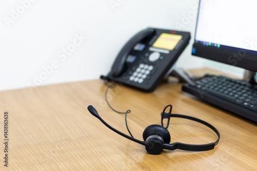 Obraz na płótnie VOIP headset for callcenter on desk at customer service office. Communication support for sale support and telemaketing Helpdeskac w salonie