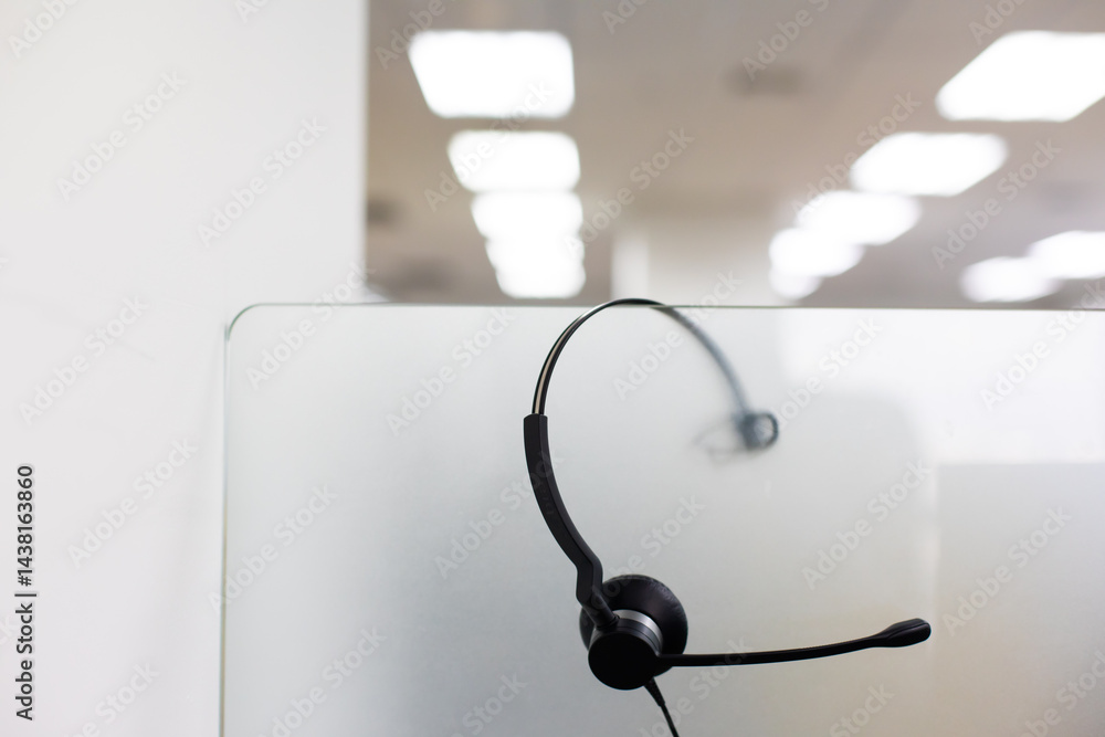 VOIP headset for callcenter on desk at customer service office. Communication support for sale support and telemaketing Helpdeskac