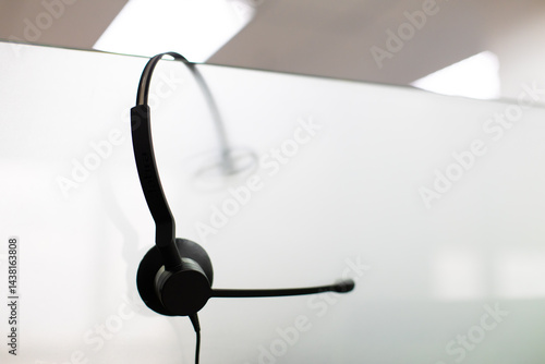 VOIP headset for callcenter on desk at customer service office. Communication support for sale support and telemaketing Helpdeskac