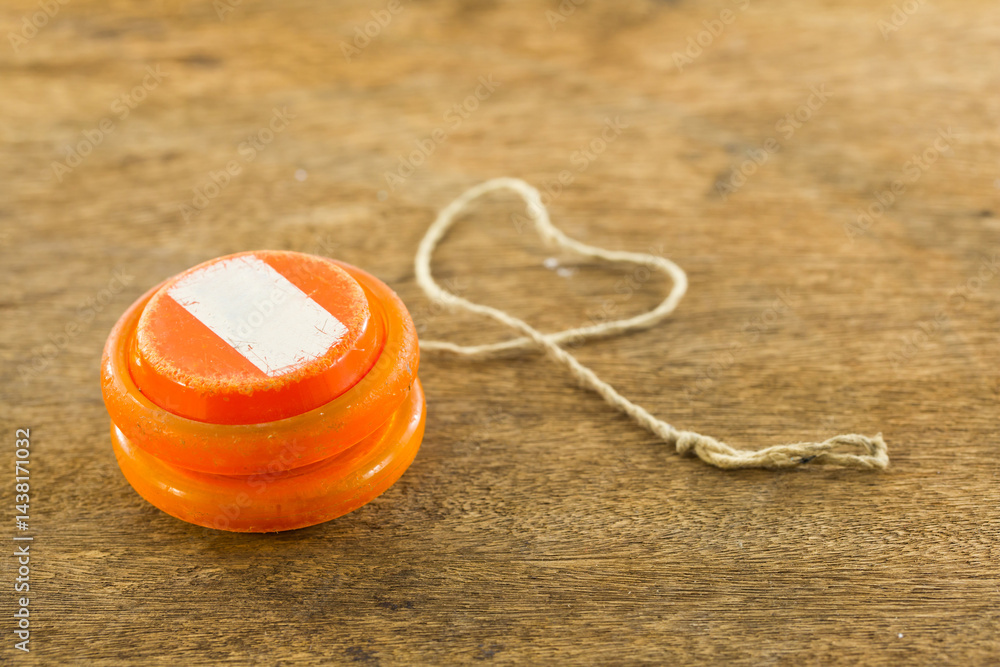 old yoyo orange isolated on wood background